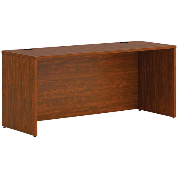 A russet cherry laminate HON credenza shell desk with a dark wood finish.