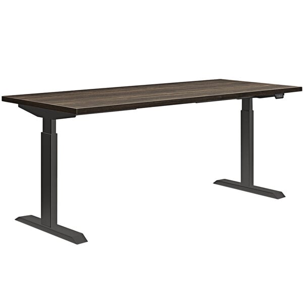 A HON Florence Walnut and Black height-adjustable desk with a metal frame.