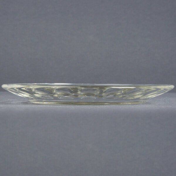 A clear glass Arcoroc dessert plate with a circular design.