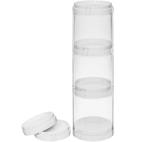 A stack of clear plastic containers with white lids.