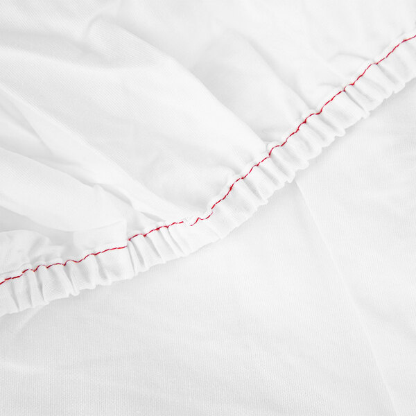 A white fabric with red stitching.