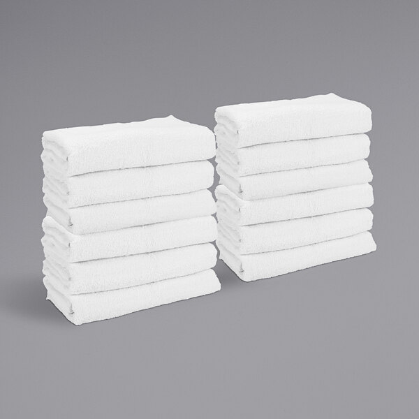 A stack of white Monarch Brands bath/gym towels.