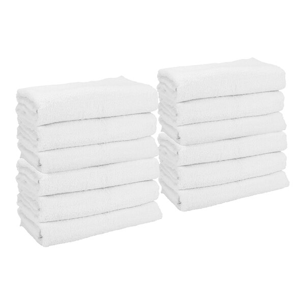 Two stacks of neatly folded white towels are shown against a plain background.
