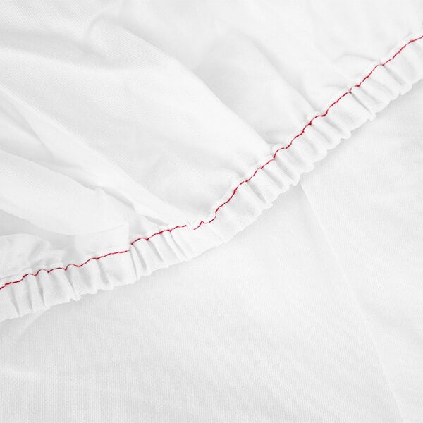 A white fabric with red stitching.