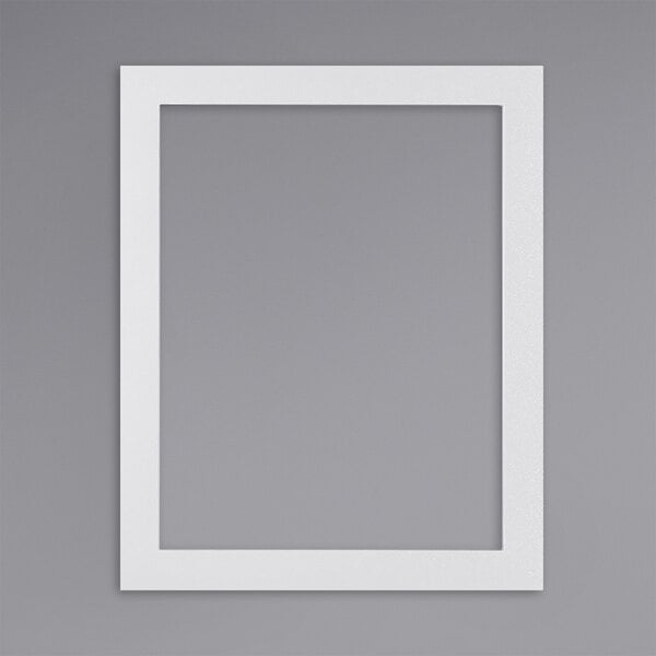 A white rectangular sign holder with a white border on a grey wall.