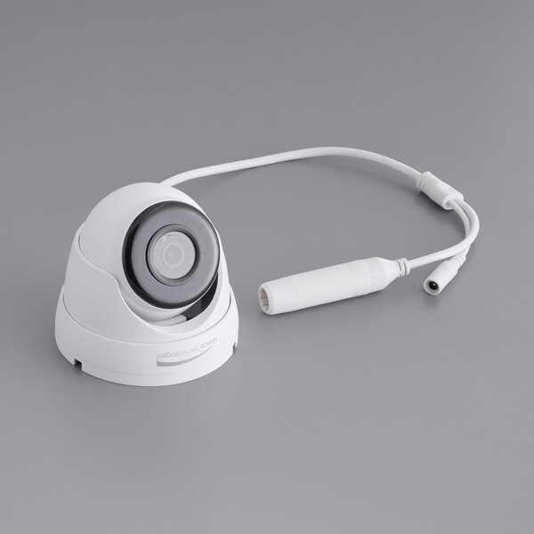 A white Speco Technologies 5MP IP camera with a cable attached.