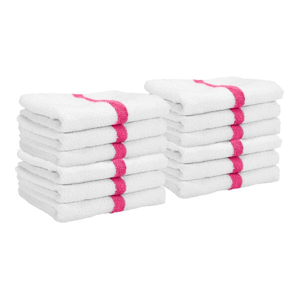 Two stacks of white towels, each with a pink stripe running through the center.