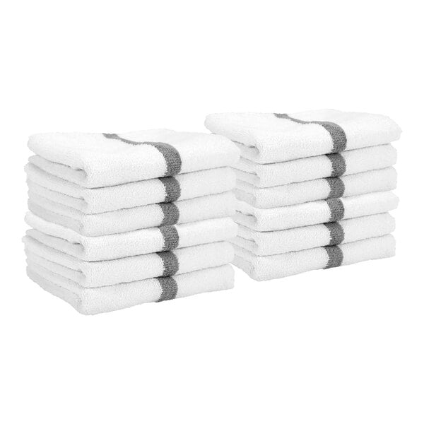Two stacks of white hand towels, each with a gray stripe running through the center.