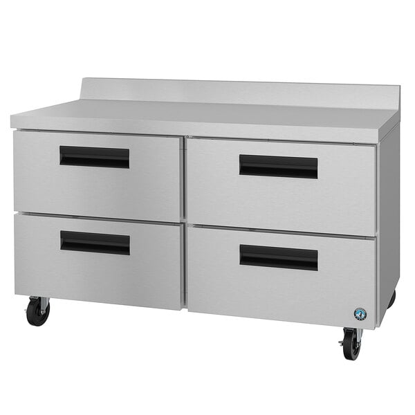 A stainless steel worktop refrigerator with four drawers.