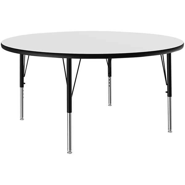 A Correll white round activity table with black legs.