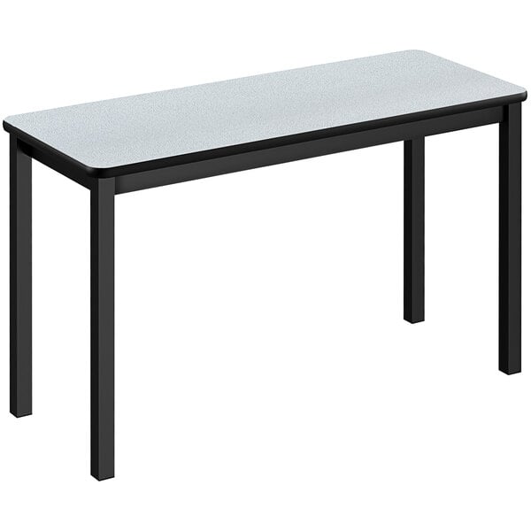 A white rectangular table with black legs.