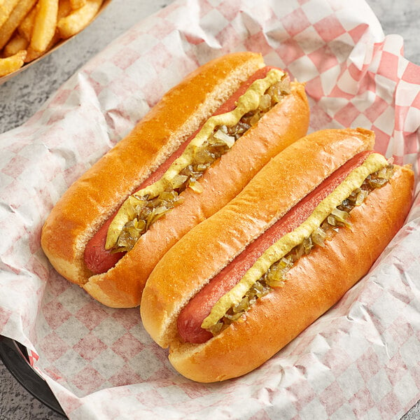 Two Nathan's Famous beef hot dogs with mustard and relish on them.