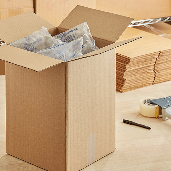 A Lavex kraft cardboard shipping box full of plastic bags.