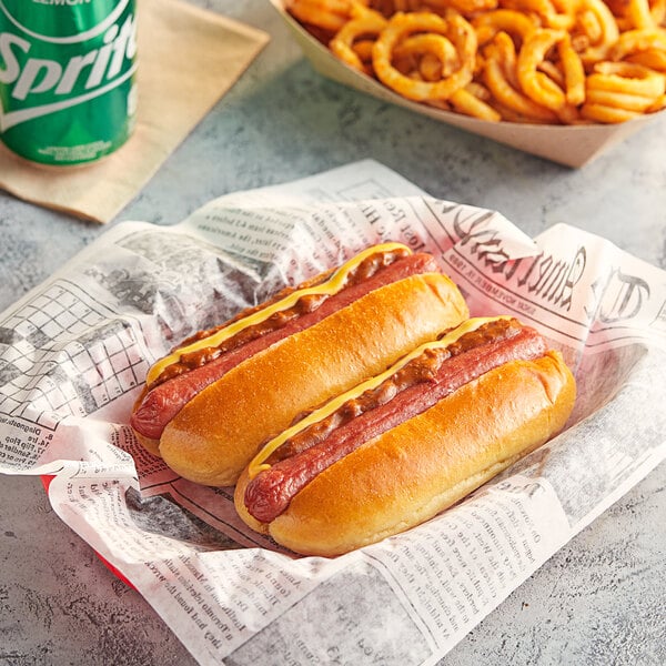 Nathan's Famous beef hot dogs in a paper basket with fries and soda.