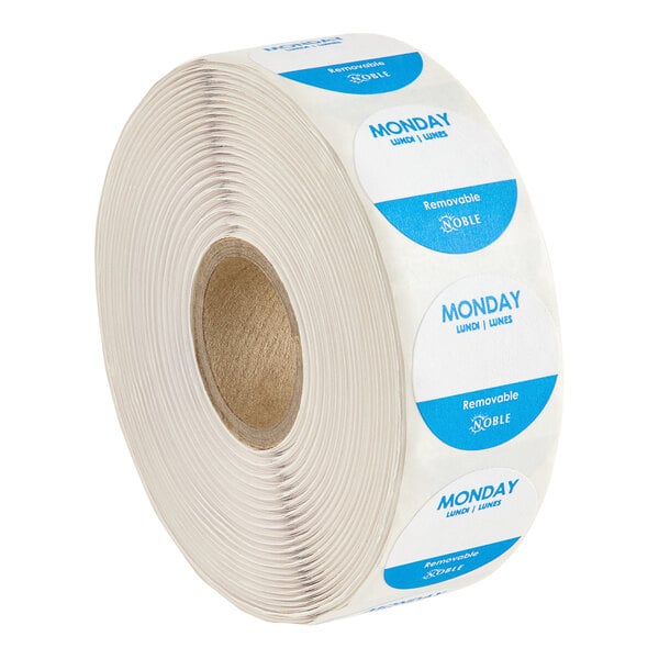 A roll of white Noble Products day of the week labels with blue writing.