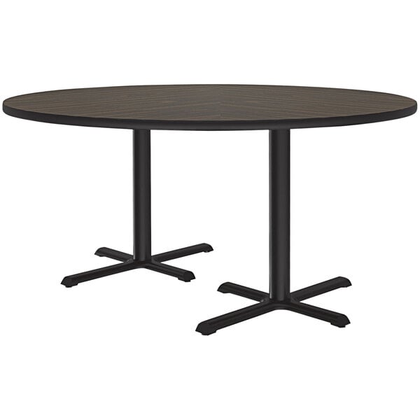 A Correll round table with a walnut finish and two black cross bases.