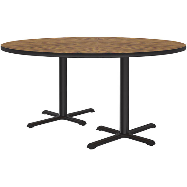 A round wooden table with black legs.
