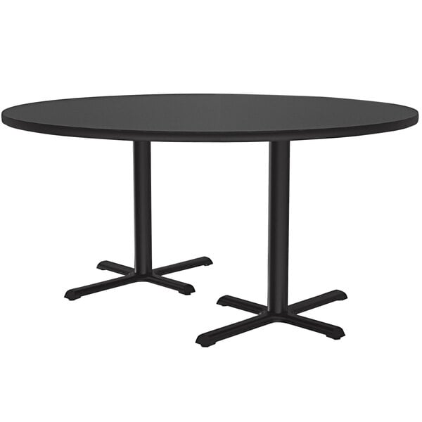 A Correll black round table with two cross bases.