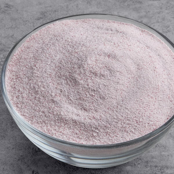 A bowl of pink powdered DOLE Soft Serve Pomegranate mix.