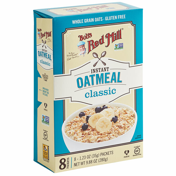 A box of Bob's Red Mill Gluten-Free Oatmeal packets with a bowl of oatmeal topped with bananas and blueberries.