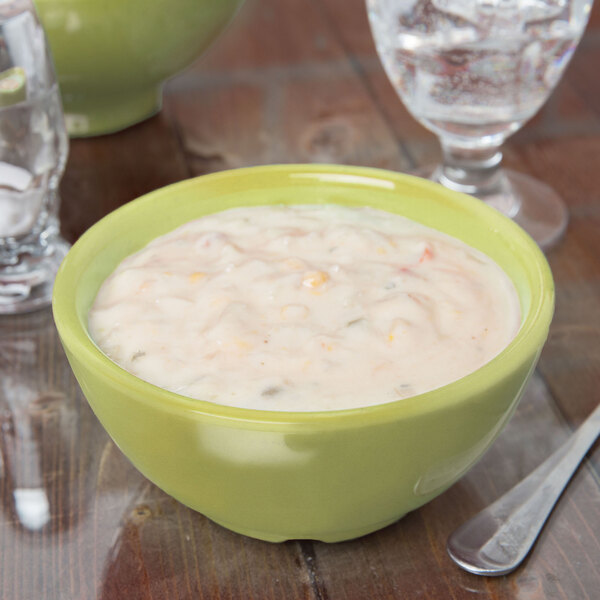 A close up of avocado soup in a green Diamond Harvest melamine bowl.