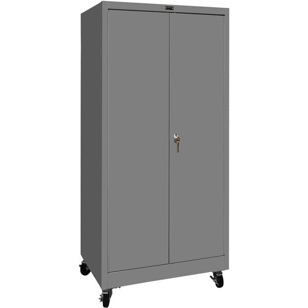 A grey metal Hallowell mobile storage cabinet with wheels and solid doors.