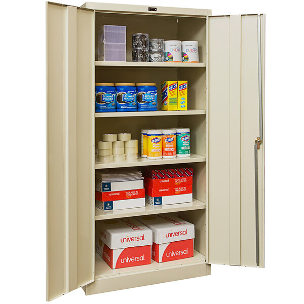 A Hallowell tan storage cabinet with solid doors storing various items.