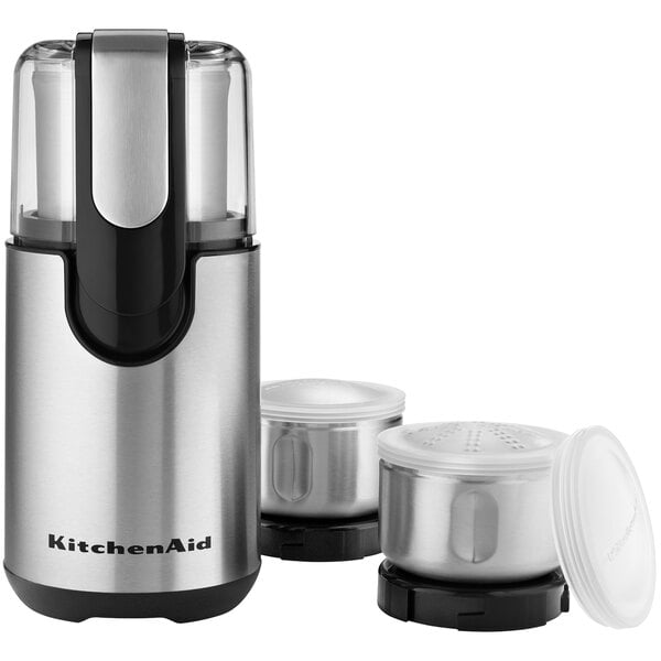 A white KitchenAid coffee and spice grinder with two containers and a lid.