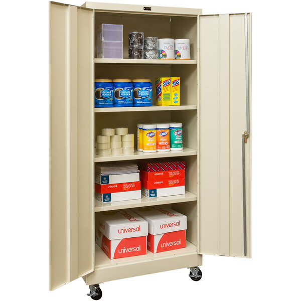 A Hallowell tan metal storage cabinet with shelves full of items.