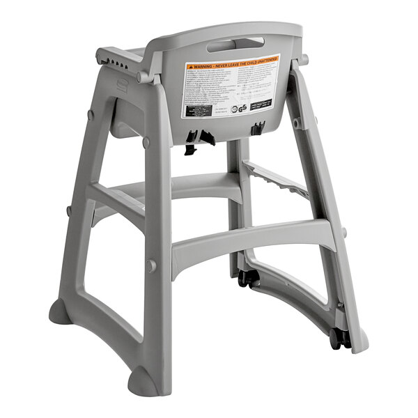 A gray plastic restaurant high chair with wheels, designed for child safety and stability.
