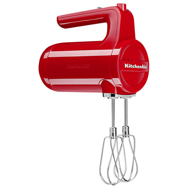 A bright red KitchenAid cordless hand mixer with a handle.