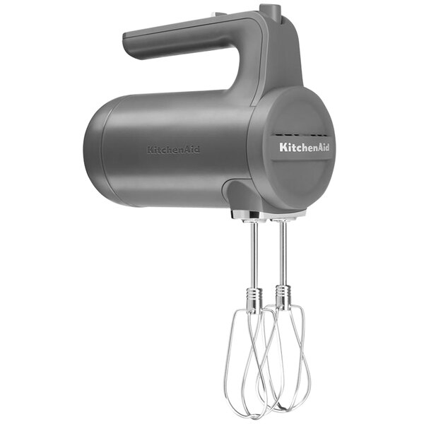 A gray KitchenAid cordless hand mixer with a handle.