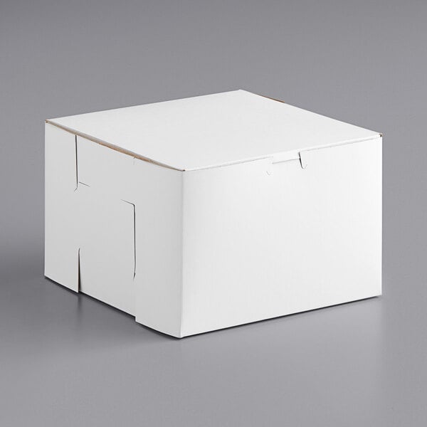 A white 9" x 9" x 6" cake box on a gray surface.