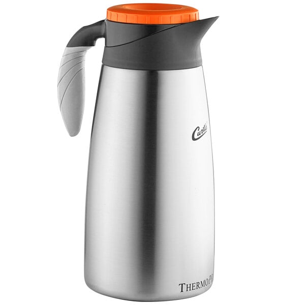 A silver Curtis stainless steel coffee server with black lid.
