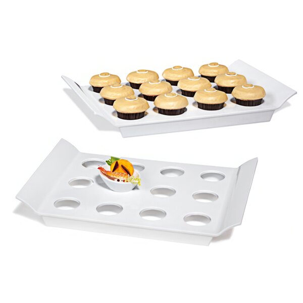 Two white GET San Michele melamine display trays with round slots holding cupcakes on a white surface.