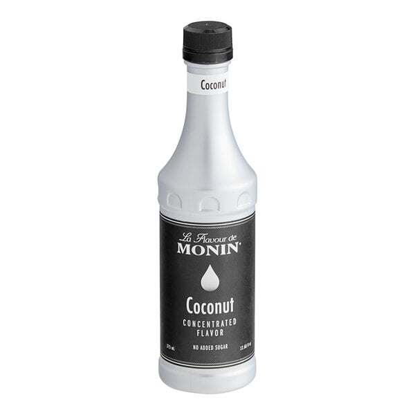 A white Monin bottle of coconut flavor with a black label.