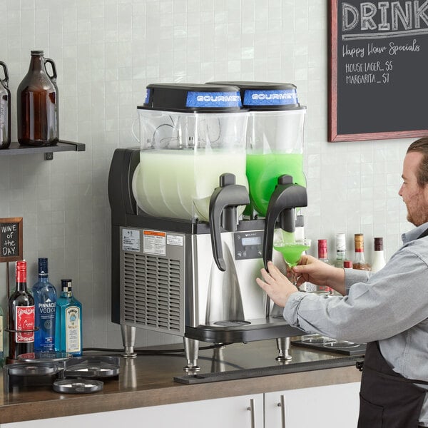 A man pouring green liquid into a Bunn Ultra NX slushy machine.