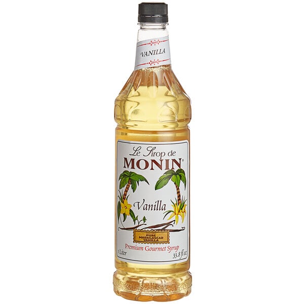 A bottle of Monin vanilla flavoring syrup with a label.