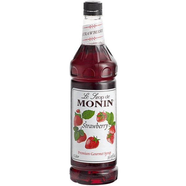 A Monin bottle of strawberry syrup.