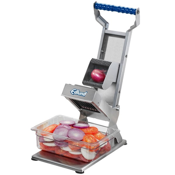 An Edlund ARC! vegetable slicer with onions in a container.