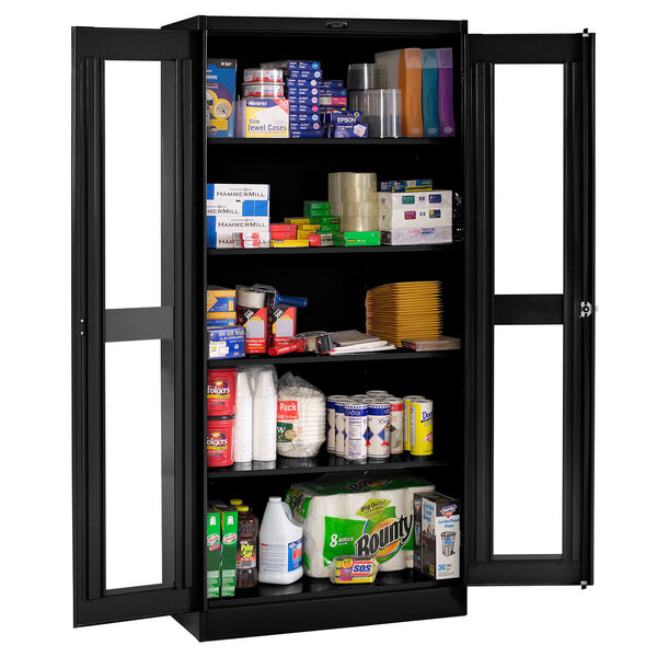 A black Tennsco deluxe storage cabinet with C-thru doors filled with a variety of products.