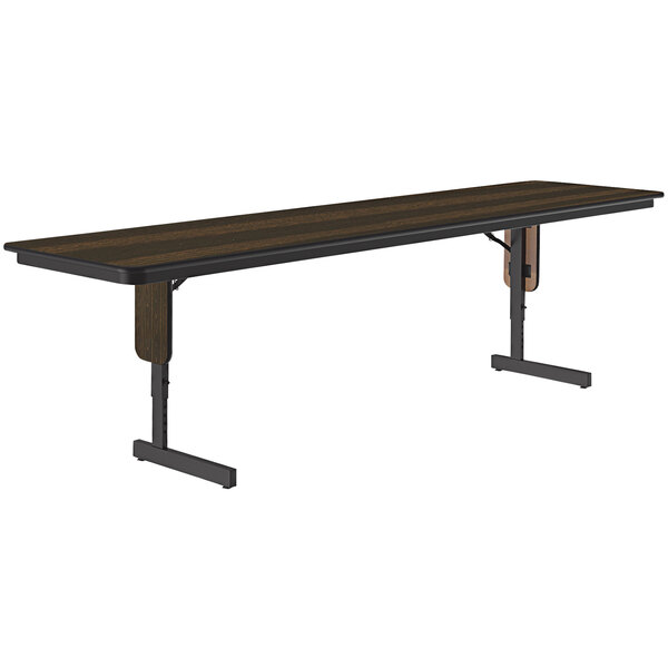 A Correll rectangular seminar table with walnut thermal-fused laminate top and panel legs.