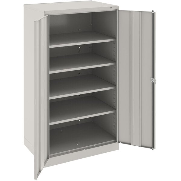 A Tennsco light gray metal storage cabinet with solid doors.