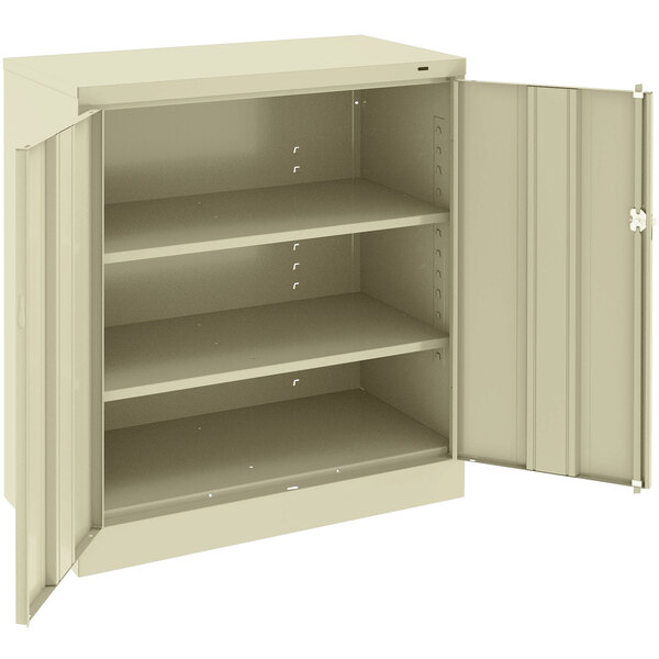 A beige metal Tennsco storage cabinet with open doors.