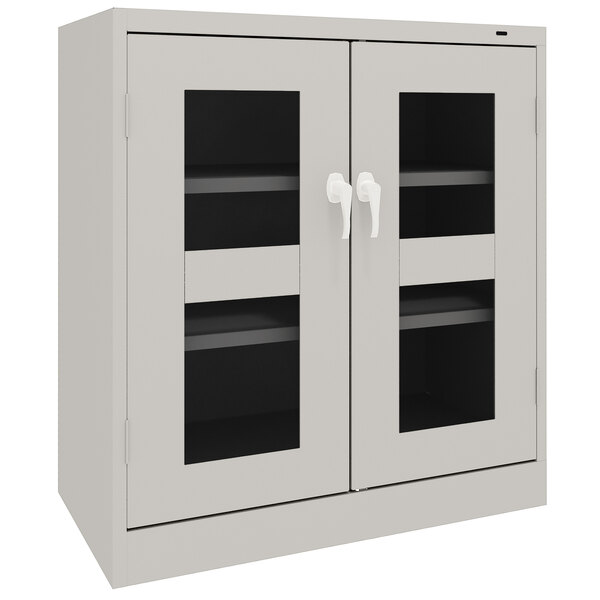 A light gray Tennsco storage cabinet with C-Thru doors.