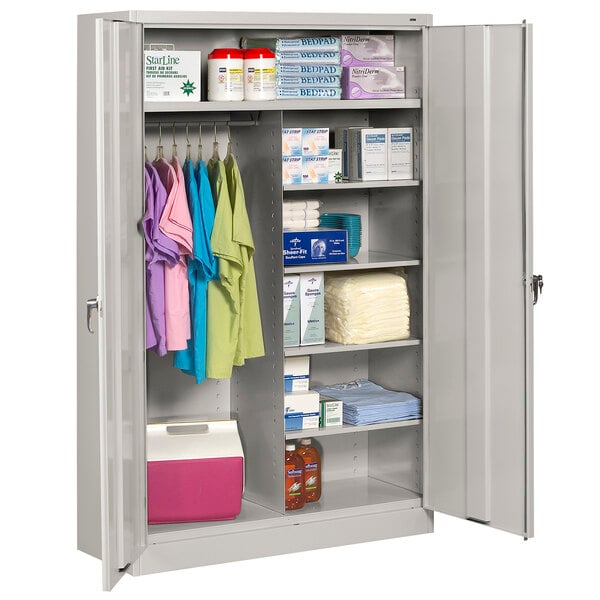 A light gray Tennsco metal combination cabinet with solid doors and items on the shelves.