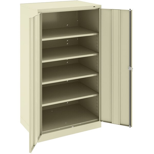 A Tennsco putty metal storage cabinet with shelves and solid doors.