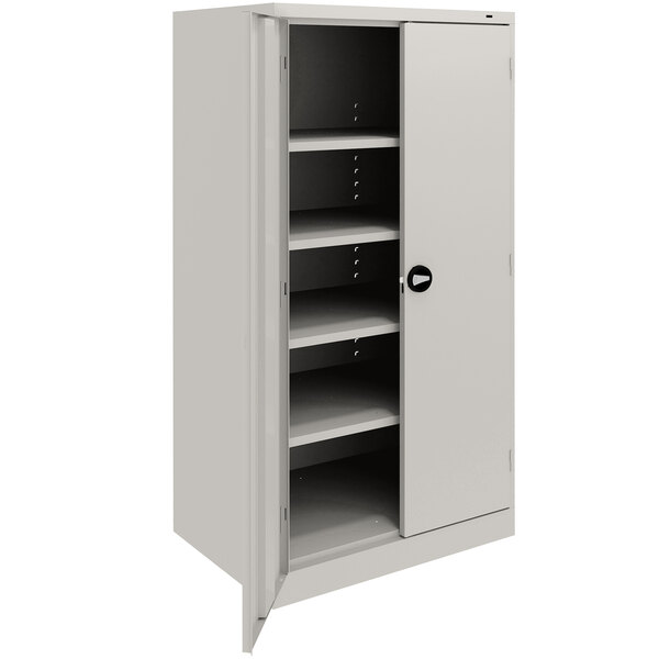 A light gray metal Tennsco storage cabinet with shelves.