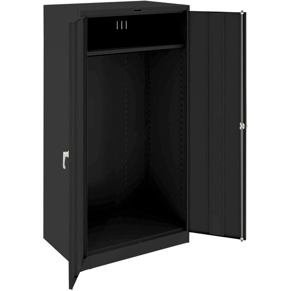 A black metal Tennsco wardrobe cabinet with open doors.