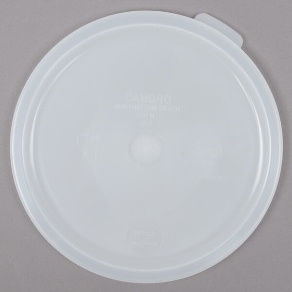 A white plastic lid for a round food storage container.